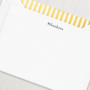 closeup of white linen envelope with yellow stripe interior with #thankyou engraved on back