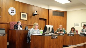 City council members work in panelled chambers during meeting