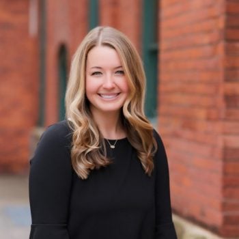 Headshot of Amanda Alibozek against red brick building